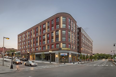 a large brick building on the corner of a city street